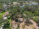 An aerial shot displays the home's location near a body of water, surrounded by mature trees and lush foliage at 11101 Corlett Rd, Riverview, FL 33578