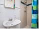Bathroom featuring a tiled shower with blue and green accents, and a sink at 11101 Corlett Rd, Riverview, FL 33578