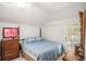 Cozy bedroom with a blue-patterned bed, wooden furniture, and ample natural light at 11101 Corlett Rd, Riverview, FL 33578