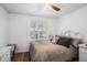 Cozy bedroom featuring neutral walls, wood floor, and natural light at 11101 Corlett Rd, Riverview, FL 33578