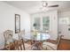 Charming dining area with a glass-top table, wrought iron chairs, and natural light streaming through the windows at 11101 Corlett Rd, Riverview, FL 33578