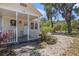 A charming front porch with a seating area, complemented by a well-maintained exterior at 11101 Corlett Rd, Riverview, FL 33578
