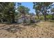 Single-story home with a welcoming front porch, nestled among mature trees and natural landscape at 11101 Corlett Rd, Riverview, FL 33578