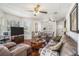 Cozy living room with gleaming hardwood floors, comfortable seating, and an abundance of natural light at 11101 Corlett Rd, Riverview, FL 33578