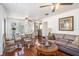 Inviting living room featuring hardwood floors, a comfortable leather couch, and an abundance of natural light at 11101 Corlett Rd, Riverview, FL 33578