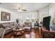 Comfortable living room featuring hardwood floors, neutral-toned furnishings, and large windows for natural light at 11101 Corlett Rd, Riverview, FL 33578