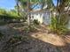 Side exterior view showcasing the home's architecture and outdoor space with mature trees at 11101 Corlett Rd, Riverview, FL 33578