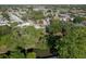 Scenic aerial view of a quiet residential neighborhood nestled among mature trees and a tranquil waterway at 10137 Oleander Dr, Port Richey, FL 34668
