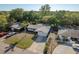 Aerial view of a well-kept home with a driveway, landscaping, and mature trees at 10137 Oleander Dr, Port Richey, FL 34668