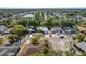 Expansive aerial view showcasing a residential area with tidy streets, lush trees, and a serene pond at 10137 Oleander Dr, Port Richey, FL 34668