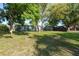 Large backyard with shade trees and grass at 10137 Oleander Dr, Port Richey, FL 34668