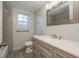 Modern bathroom with gray vanity, updated fixtures, and tiled shower at 10137 Oleander Dr, Port Richey, FL 34668