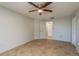 Bedroom with tile flooring, a ceiling fan, a closet, and access to an ensuite bathroom at 10137 Oleander Dr, Port Richey, FL 34668