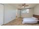 Cozy bedroom with tiled floor, ceiling fan, closet, and a bathroom at 10137 Oleander Dr, Port Richey, FL 34668