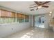 Bright dining area with tile flooring, ceiling fan, and sliding glass doors to the outdoor patio at 10137 Oleander Dr, Port Richey, FL 34668
