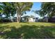 Charming home with green grass, mature trees and a cozy front porch at 10137 Oleander Dr, Port Richey, FL 34668