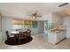 Open kitchen and dining area with tile flooring, ample cabinets, and abundant natural light at 10137 Oleander Dr, Port Richey, FL 34668