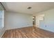 Bright living room with hardwood flooring, natural light, and an open doorway to the kitchen at 10137 Oleander Dr, Port Richey, FL 34668
