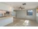 Open living area with tile flooring, a ceiling fan, and a large window to let in natural light at 10137 Oleander Dr, Port Richey, FL 34668