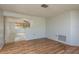 Bright living room featuring hardwood floors, white walls, and an open floor plan, providing ample space at 10137 Oleander Dr, Port Richey, FL 34668