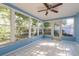 Bright sunroom featuring tiled floors and large windows providing lots of natural light at 10137 Oleander Dr, Port Richey, FL 34668