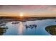 Scenic aerial view of community lagoon during sunset at 10240 Trumpet Honeysuckle Way, San Antonio, FL 33576
