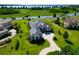 Aerial view of house showing beautifully landscaped yard overlooking lake at 10509 Broadland Pass, Thonotosassa, FL 33592