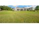 Expansive backyard featuring a screened-in lanai, ideal for outdoor living and entertaining at 10509 Broadland Pass, Thonotosassa, FL 33592