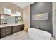 Bathroom featuring an oversized mirror, spacious vanity and unique beach themed artwork at 10509 Broadland Pass, Thonotosassa, FL 33592