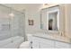 Bright bathroom features a glass enclosed shower and granite countertop at 10509 Broadland Pass, Thonotosassa, FL 33592