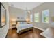 Bright bedroom with hardwood floors, a ceiling fan, and three sunny windows at 10509 Broadland Pass, Thonotosassa, FL 33592