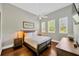 Comfortable bedroom with hardwood floors, ceiling fan, and plenty of natural light at 10509 Broadland Pass, Thonotosassa, FL 33592