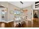 A dining room featuring a large table, hardwood floors, a modern light fixture, and views of the pool at 10509 Broadland Pass, Thonotosassa, FL 33592