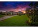 Gorgeous home exterior with pristine landscaping and a striking sunset sky at 10509 Broadland Pass, Thonotosassa, FL 33592