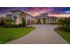 Stunning modern home featuring a three-car garage, meticulously landscaped yard, and a grand entrance at 10509 Broadland Pass, Thonotosassa, FL 33592