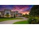 Elegant home exterior featuring modern architecture, well-maintained landscaping, and a circular driveway at 10509 Broadland Pass, Thonotosassa, FL 33592