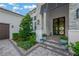 Elegant stone accents enhance the front entrance with meticulously landscaped garden beds at 10509 Broadland Pass, Thonotosassa, FL 33592