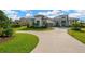 A stunning home has an expansive lawn and long driveway at 10509 Broadland Pass, Thonotosassa, FL 33592