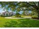 Expansive front yard with circular drive leading to a modern two-story home with manicured landscaping at 10509 Broadland Pass, Thonotosassa, FL 33592