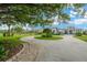 An elegant home is shown with a long circular driveway and mature tree providing shade at 10509 Broadland Pass, Thonotosassa, FL 33592
