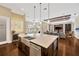 Open concept kitchen with large island, stainless appliances, and seamless flow to the dining and living areas at 10509 Broadland Pass, Thonotosassa, FL 33592