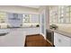 Modern kitchen featuring a wine fridge, white cabinets, and stainless appliances at 10509 Broadland Pass, Thonotosassa, FL 33592