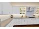 Bright kitchen featuring white cabinets, stainless appliances, lots of counter space, and recessed lighting at 10509 Broadland Pass, Thonotosassa, FL 33592