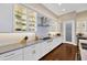 This kitchen features white cabinets, stainless appliances and a long countertop with recessed lighting at 10509 Broadland Pass, Thonotosassa, FL 33592