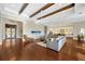 Spacious living room with hardwood floors, coffered ceilings, and an open layout at 10509 Broadland Pass, Thonotosassa, FL 33592