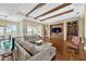 Bright living space showcasing hardwood floors, coffered ceilings, and natural light at 10509 Broadland Pass, Thonotosassa, FL 33592