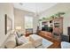 Comfortable living room features a ceiling fan, large entertainment center, and hardwood floors at 10509 Broadland Pass, Thonotosassa, FL 33592