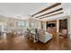 Large living space with hardwood floors, coffered ceilings, and an open floor plan at 10509 Broadland Pass, Thonotosassa, FL 33592