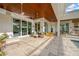 Expansive covered patio featuring multiple seating areas and sliding glass doors at 10509 Broadland Pass, Thonotosassa, FL 33592