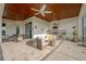 Comfortable covered patio with ceiling fans, outdoor kitchen, and seating area at 10509 Broadland Pass, Thonotosassa, FL 33592